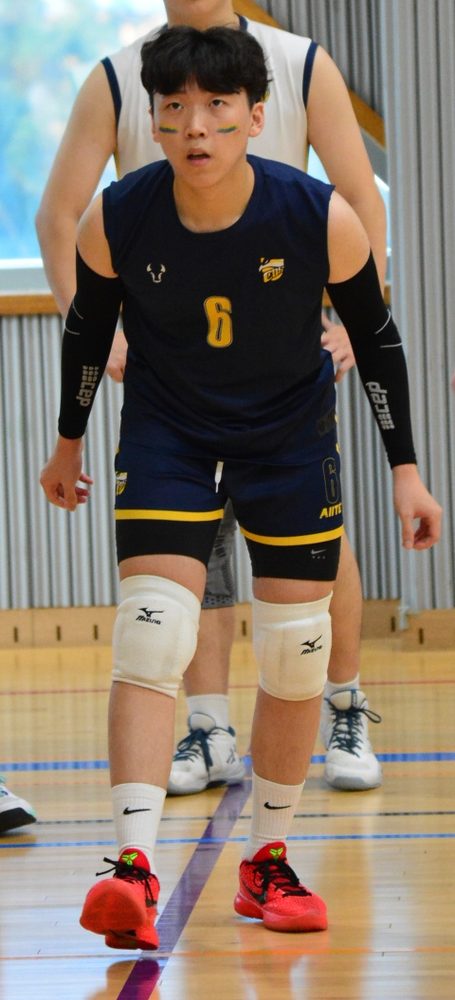 Yunwoo, number 6, ready to receive in a volleyball match